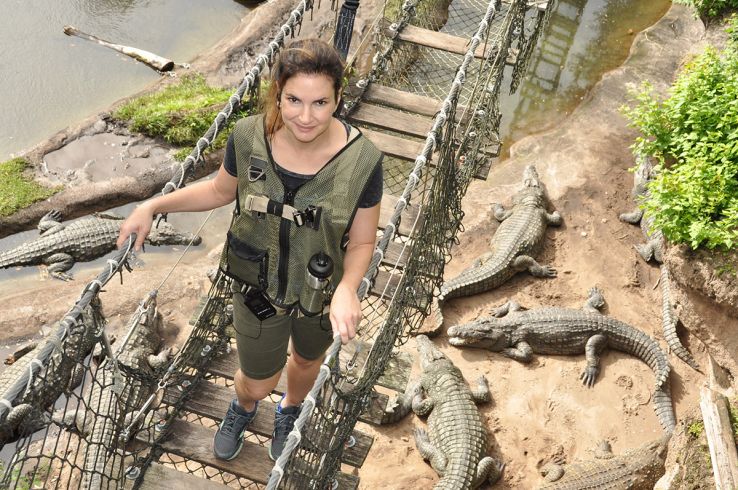 Bridig Troan on a rickety bridge above large hungry aligators