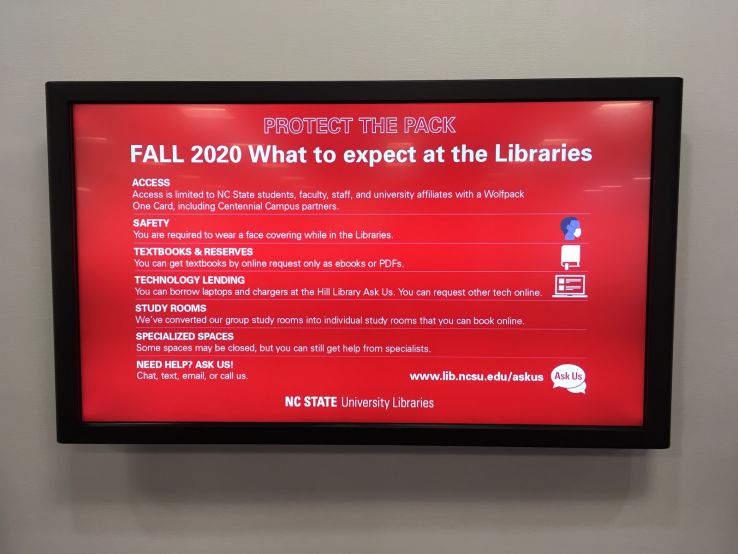 An eboard at the Libraries with information about what to expect when visiting during Fall 2020.