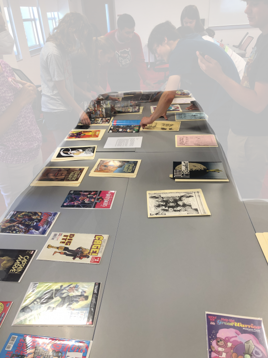 Comic books and zines on a table for students to examine.