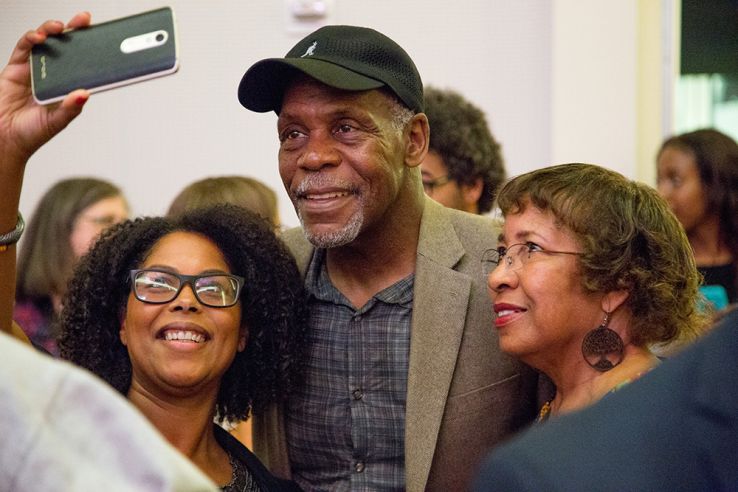 Reception attendees pose for photos with actor Danny Glover at the Talley Student Center. 