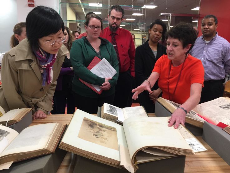 an image of Eli Brown discussing Special Collections materials with event attendees at the Library