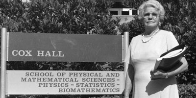 1960: Gertrude Cox standing in front of the building that bears her name. Cox Hall has been the primary home of PAMS since the college's founding.